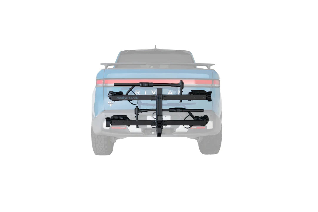 A black hitch-mounted bicycle carrier rack attached to the rear of a light blue pickup truck, shown from the back on a plain white background.