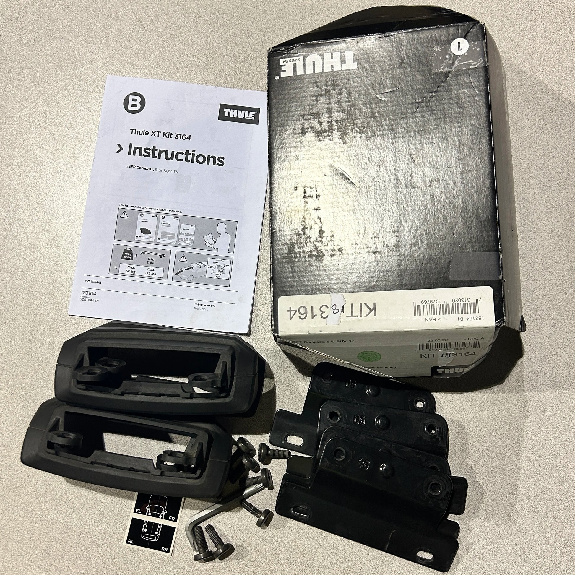 Thule Fit Kit 3164 complete kit laid out with manual, box, and components