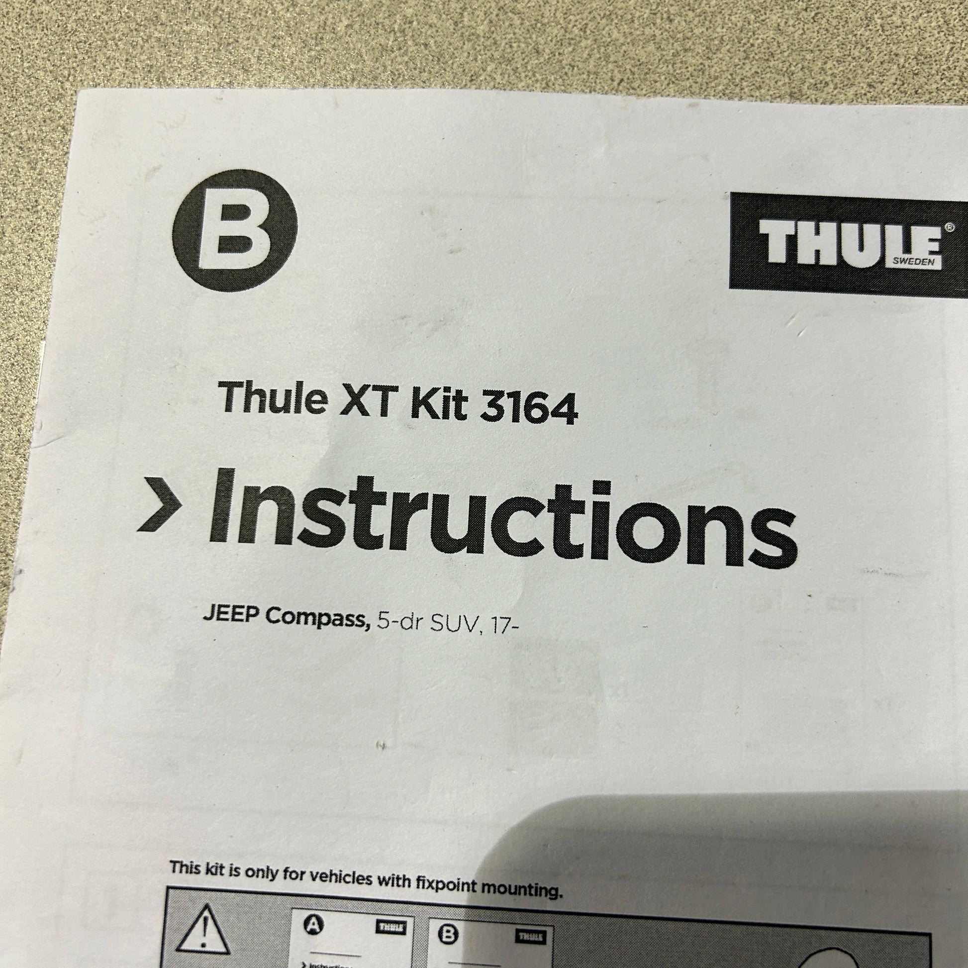 Close-up of Thule Fit Kit 3164 instruction booklet for Jeep Compass

