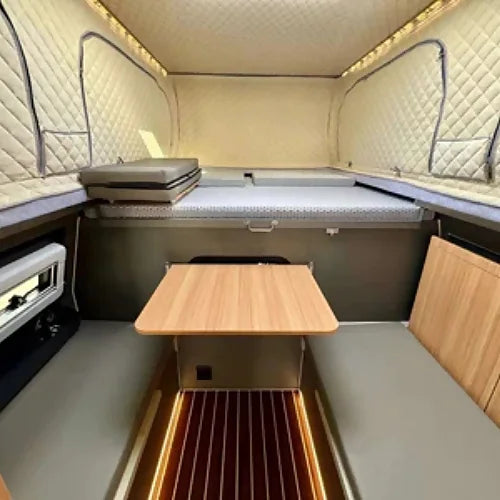 Interior view with dinette table, seating, and LED lighting