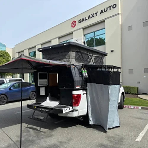 4th Gen truck camper with side awning deployed and rear door open