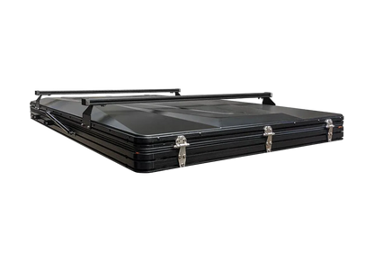 A black hard-shell roof rack carrying case with latches and a top handle, shown on a plain white background.