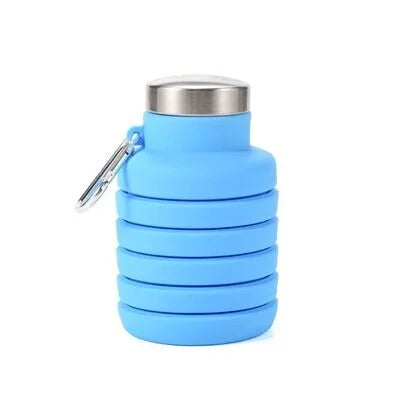 Light blue collapsible silicone water bottle fully collapsed with cap attached
