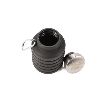 Black collapsible silicone water bottle partially collapsed with cap removed and placed nearby

