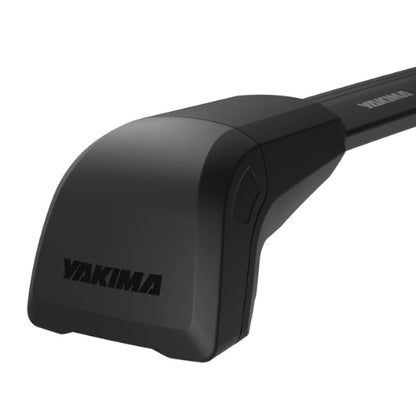 Close-up of Yakima BaseLine FX integrated crossbar end tower in matte black finish, showing aerodynamic housing with Yakima logo for naked roof vehicle roof rack system.