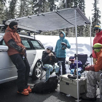 OverNOut roof rack awning providing shelter during winter camping and outdoor gathering