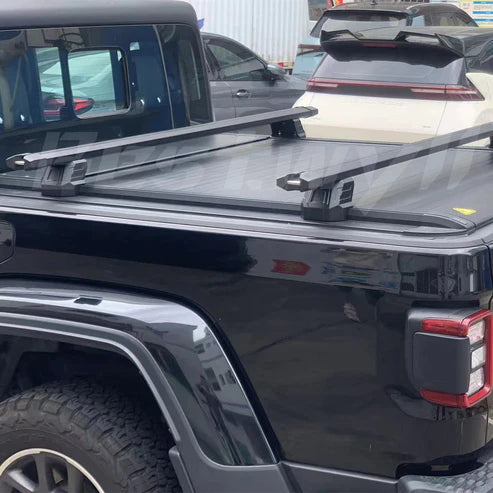 Black truck with a bed rack in an outdoor setting
