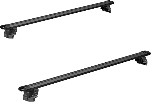 Black lockable bed rack crossbars mounted across a retractable hard tonneau cover on a pickup truck bed.