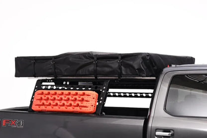 Black cargo bag on a truck bed with orange traction board