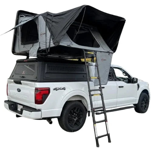 White truck with a side opening rooftop tent and ladder on a white background
