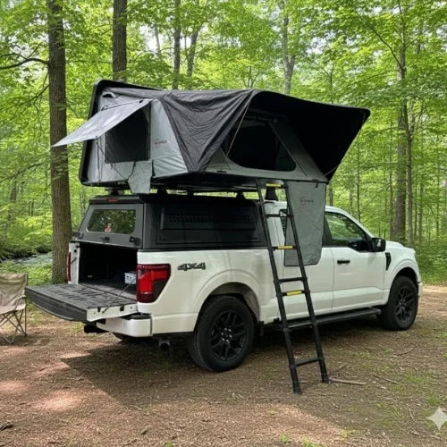 White 4x4 truck with a canopy roof rack and a open rooftop tent in a camp setting