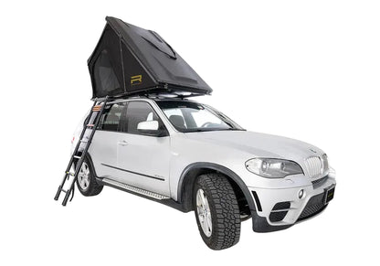 Car with a rooftop tent attached on a white background