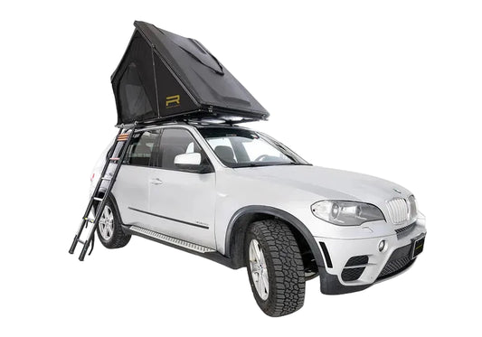 Car with a rooftop tent attached on a white background