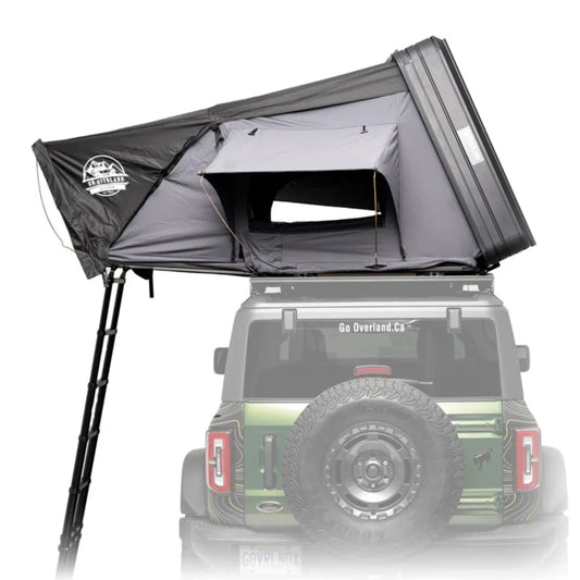 Roof top tent attached to a vehicle with 'Go Overland' branding.