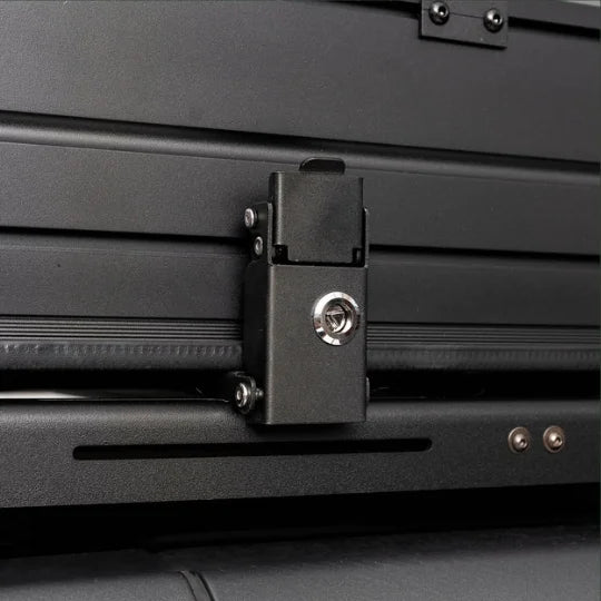 Close-up of a black lockable metal latch on a vehicle's rooftop tent.