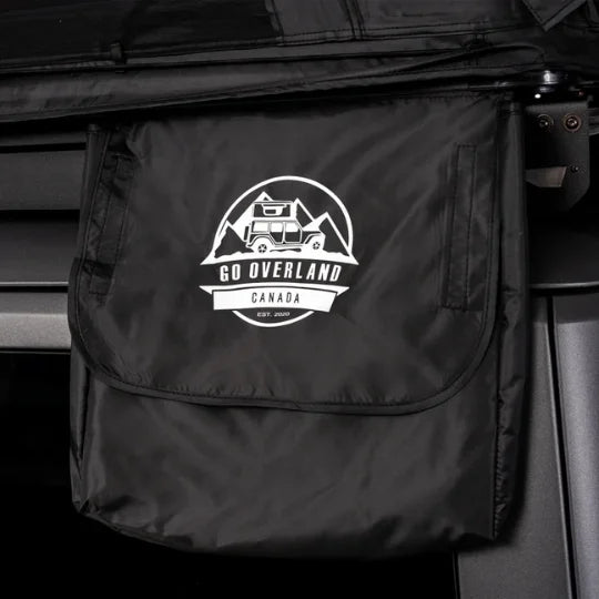 Black shoe bag with 'Go Overland Canada' logo attached to a vehicle