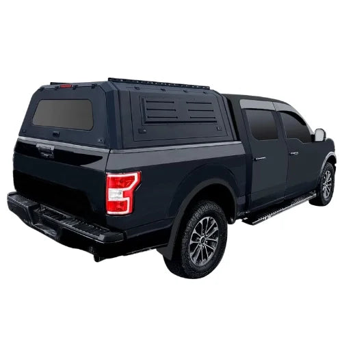 gullwing aluminum truck cap and truck canopy with roofrails installed on a black pickup truck