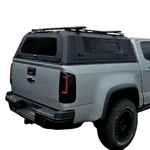 chevy silverado gullwing aluminum truck cap and truck canopy with roofracks installed on a grey chevy silverado