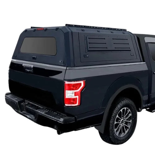 toyota tacoma gullwing aluminum truck cap and truck canopy with roofracks installed on a dark blue toyota tacoma