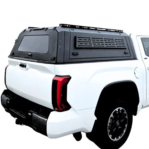 toyota tundra gullwing aluminum truck cap and truck canopy with roofracks installed on a white toyota tundra