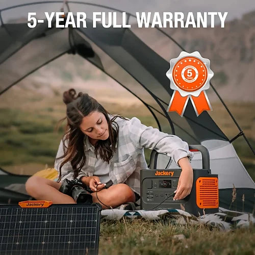 Woman using Jackery SolarSaga 80W Solar Panel with Jackery power station in a tent, 5-year full warranty outdoor solar charging setup