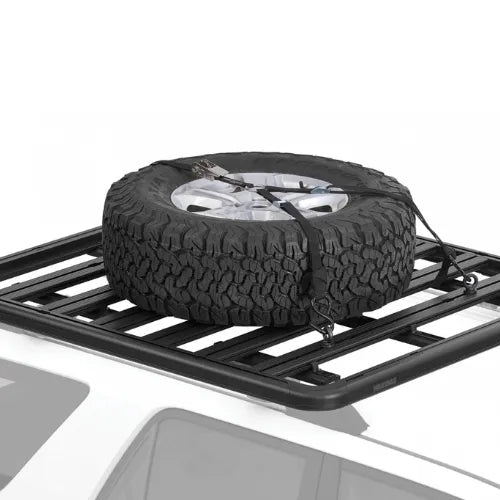 Roof rack with a spare tire on a white background