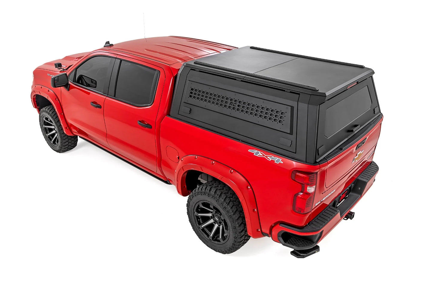 Red truck with a black tonneau cover on a white background