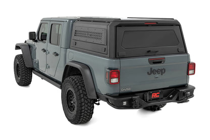 Gray Jeep Gladiator with a hard lid on a white background