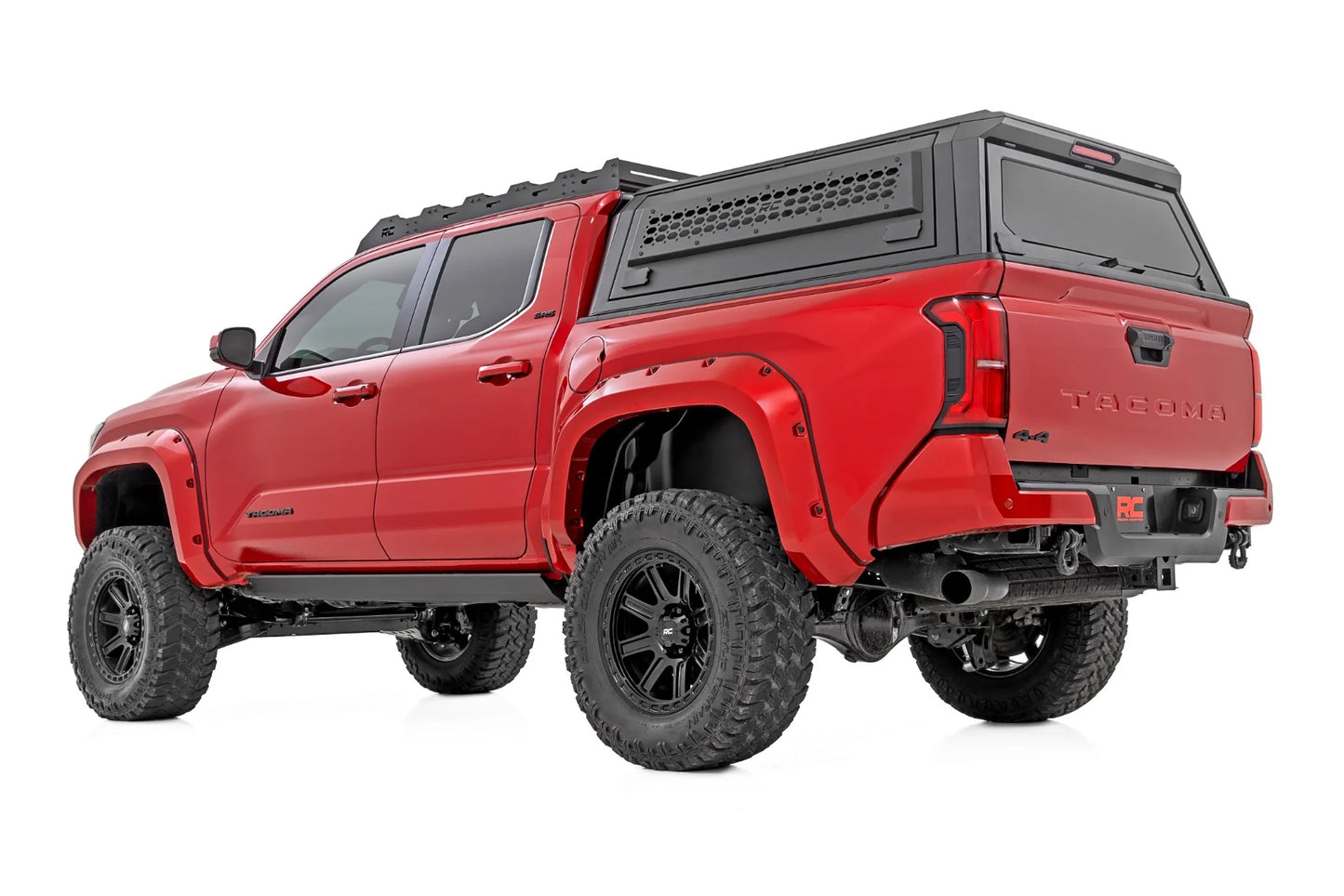Red pickup truck with a black bed cover on a white background