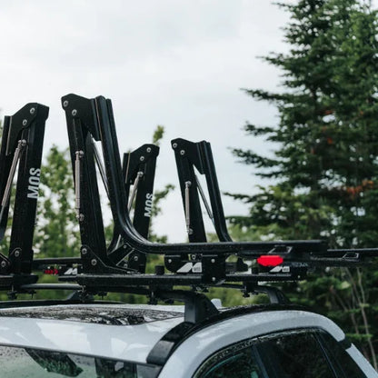 MOS UpLift™ Universal Lift Assist Rack System installed on a car with trees in the background