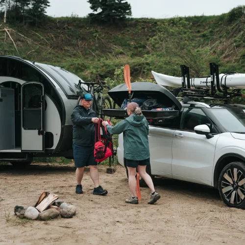 MOS UpLift™ Universal Lift Assist Rack System installed on a car with hill in the background and with someone loading the cargo box which is tilted down