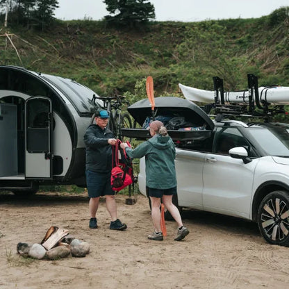 MOS UpLift™ Universal Lift Assist Rack System installed on a car with hill in the background and with someone loading the cargo box which is tilted down