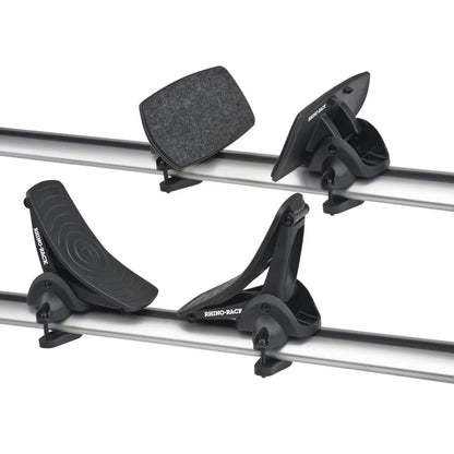 Close-up of Rhino-Rack Nautic 571 kayak carrier cradles mounted on crossbars, showing both front rubber and rear felt-padded supports.