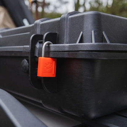 Close-up of Rhino-Rack Cargo Case latch with red padlock.
