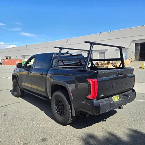 Pickup truck with adjustable bed rack installed, viewed from rear-side angle