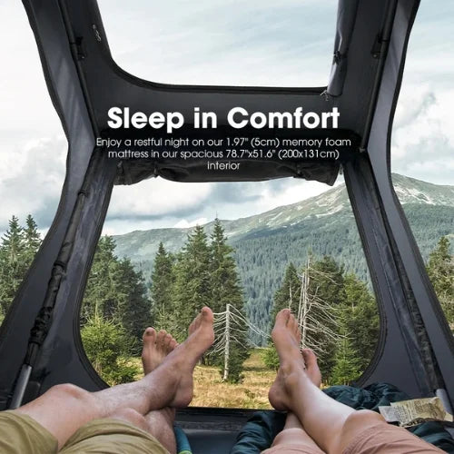 Person lying inside a san hima hotham rooftop tent with a window view of mountains and trees, promoting a 1.97-inch memory foam mattress and skyview window