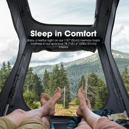 Person lying inside a san hima hotham rooftop tent with a window view of mountains and trees, promoting a 1.97-inch memory foam mattress and skyview window
