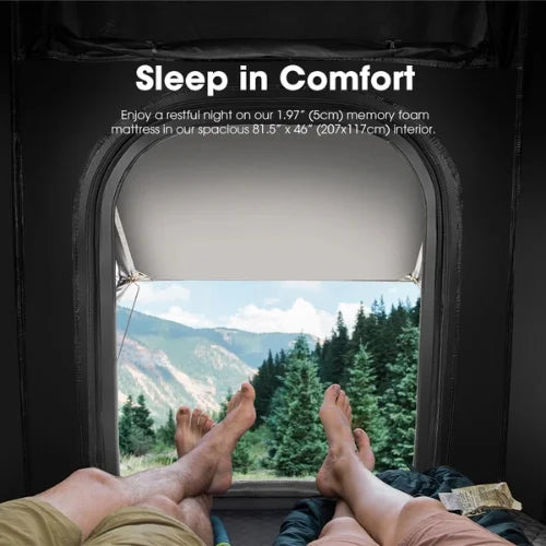 Person lying inside a san hima hotham lite rooftop tent with a window view of mountains and trees, promoting a 1.97-inch memory foam mattress.