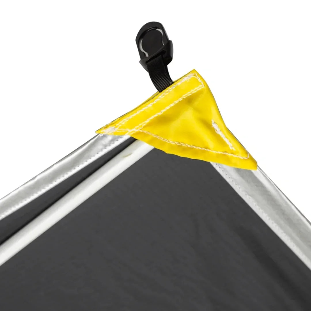 Corner of a black fabric of shady boy awning with a yellow corner flap and black clip on a white background