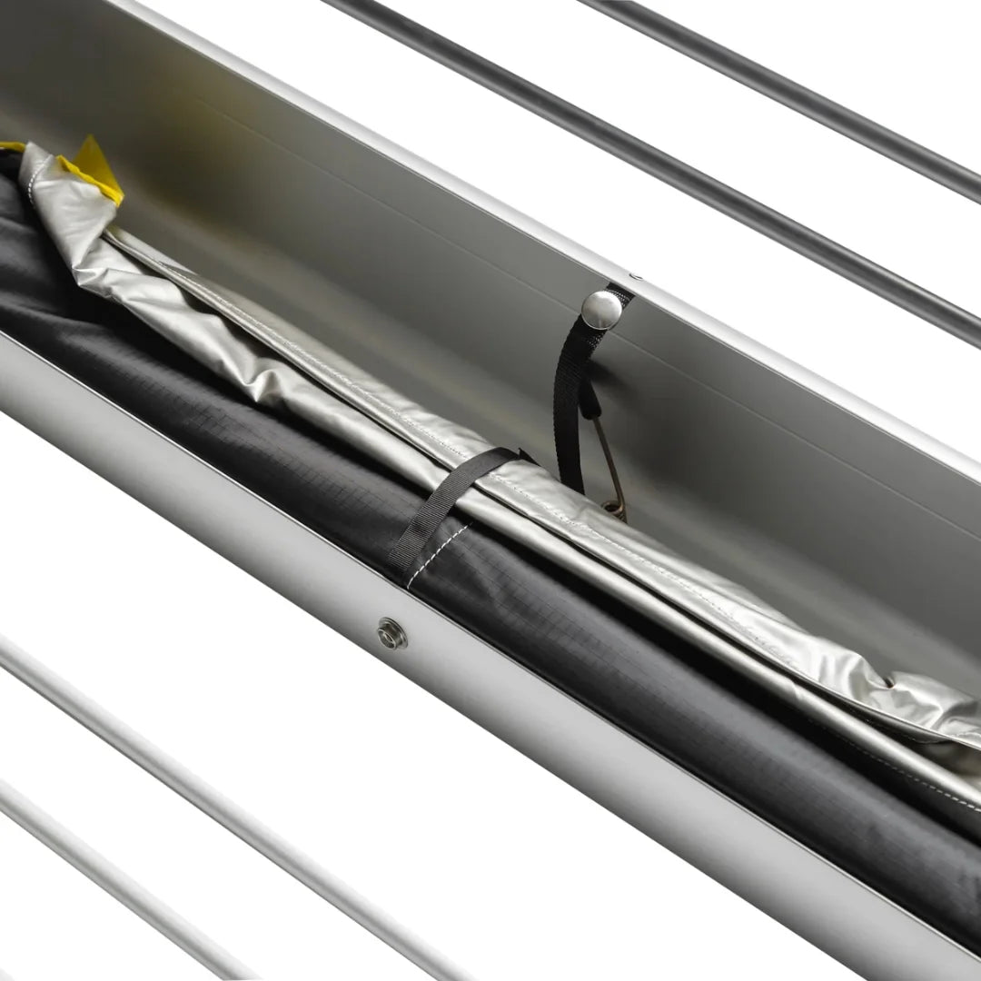 Close-up of a folded shady boy awning attached to a metallic surface with a reflective material underneath.