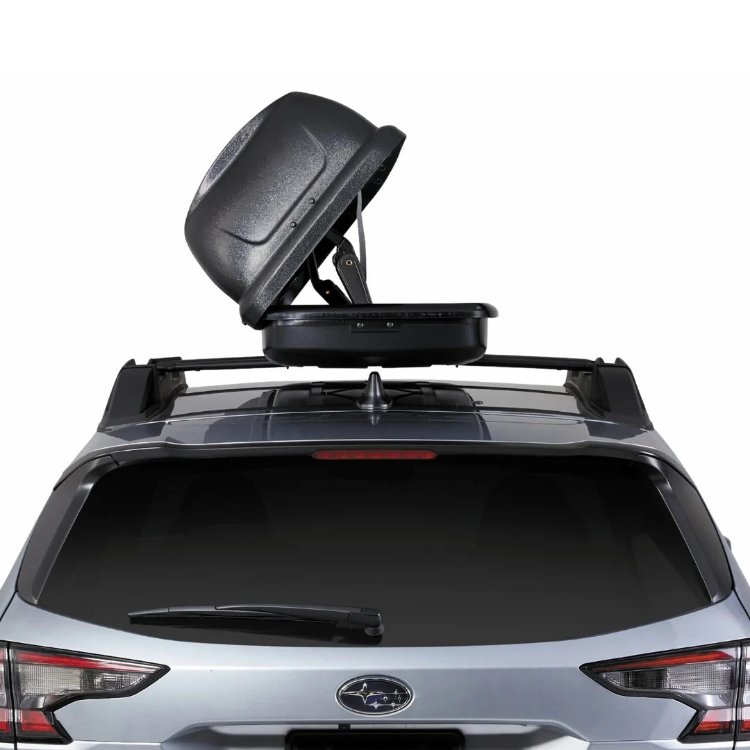 Roof box open with upward-lifted lid viewed from behind the car.