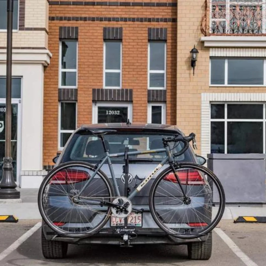 Rear view of a car with two bikes mounted on the Swagman XC2 bike rack.