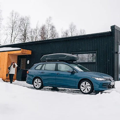 Thule Force 3 M cargo box mounted on blue station wagon in snowy driveway