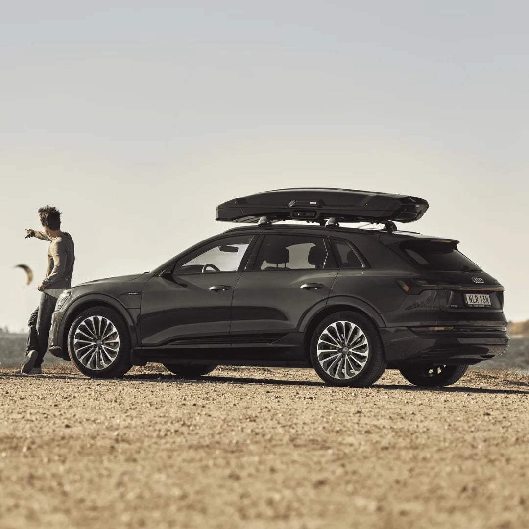 Car in desert landscape with Thule Vector Alpine cargo box mounted