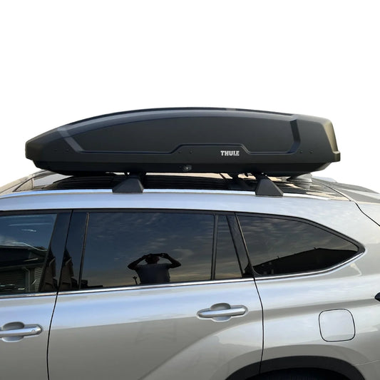 Car with a Thule roof box on a white background