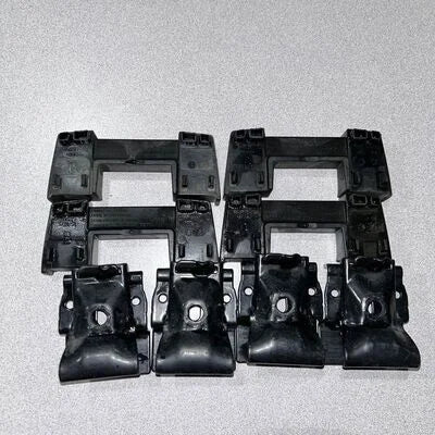 Set of black plastic brackets on a gray background