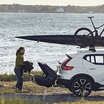 White SUV with kayak and bike on roof, Thule Arcos cargo box on hitch – versatile storage solution keeping roof free for sports gear
