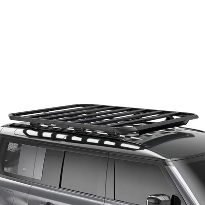 Thule Caprock Platform installed on the roof of a black van, showcasing its low-profile fitment.