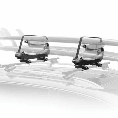 Thule surfboard carrier with two padded cradles installed on a vehicle roof rack