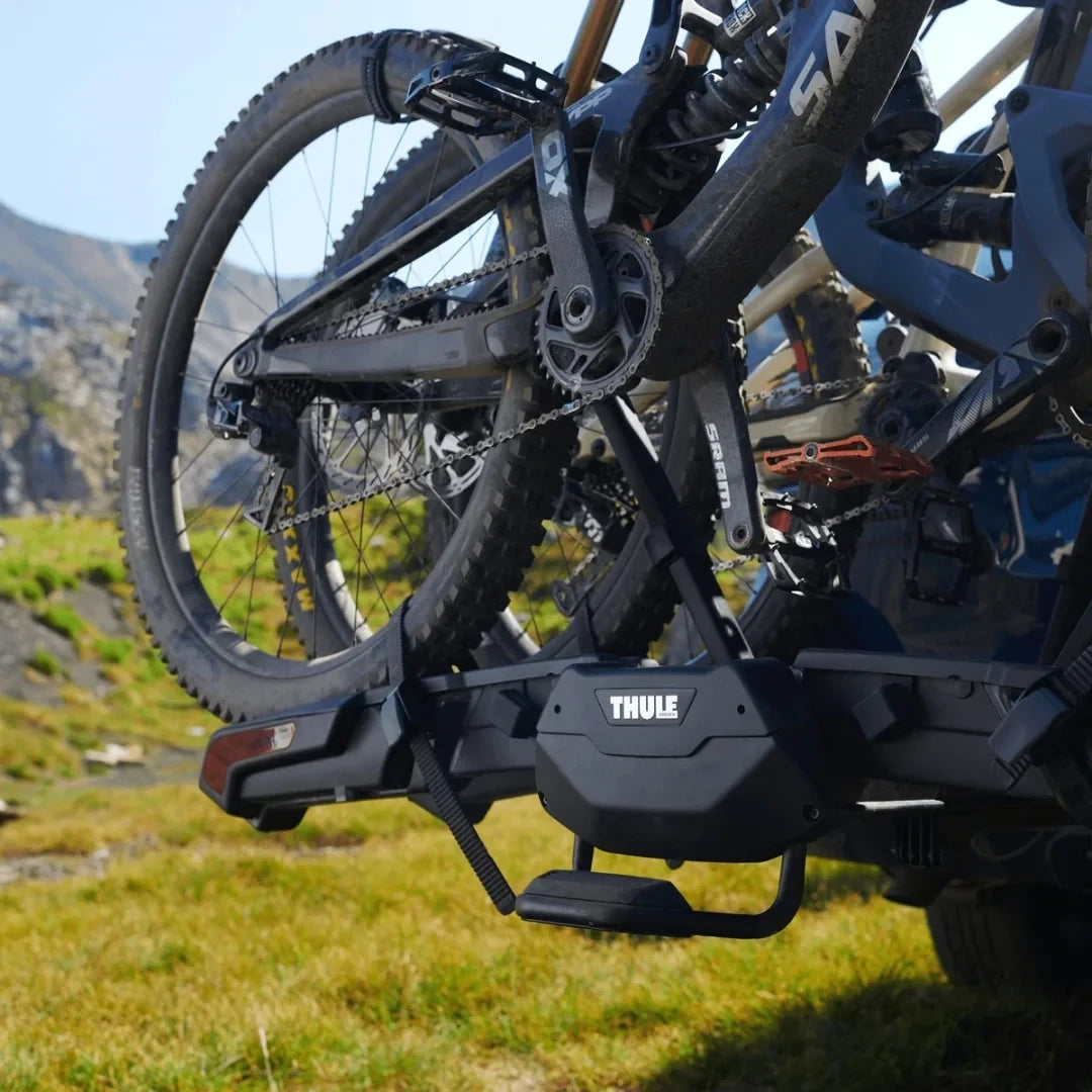 Close-up of two bikes mounted on Thule Epos in a mountain setting